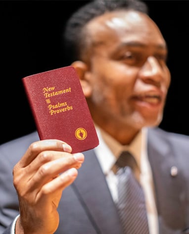 Man holding a Gideon bible