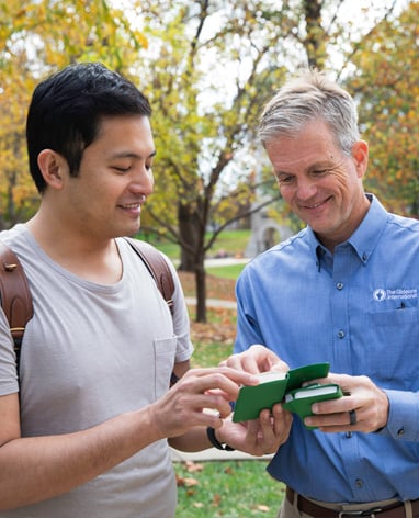 Man showing a bible to a church leader