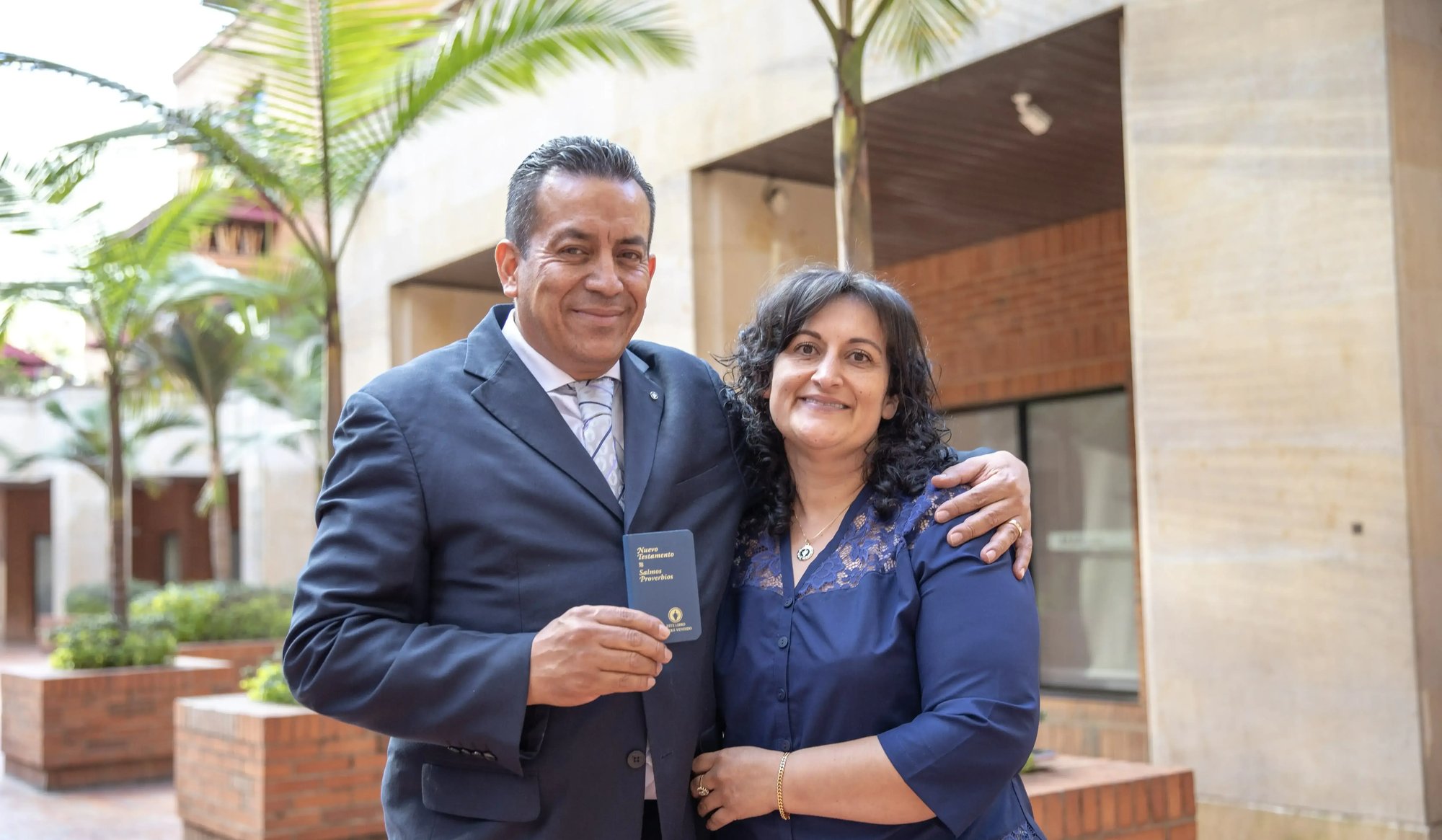 Man and woman smiling while looking at camera