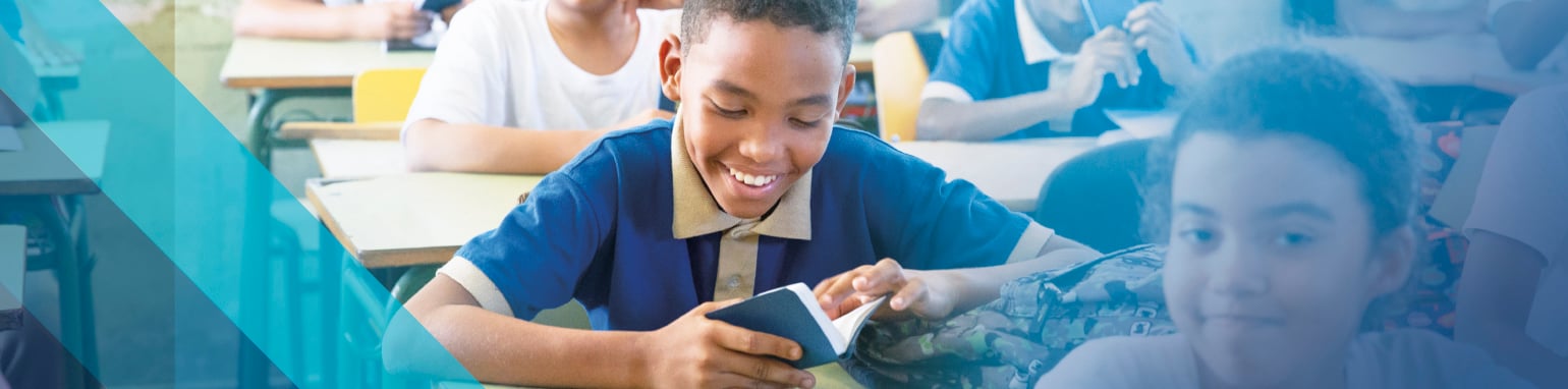 Student reading a bible at a desk