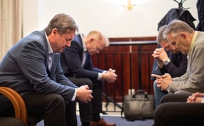 Per Inge and fellow Gideons pray together during their Saturday morning prayer breakfast.