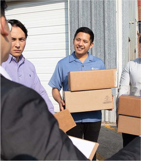 Man holding box of bibles
