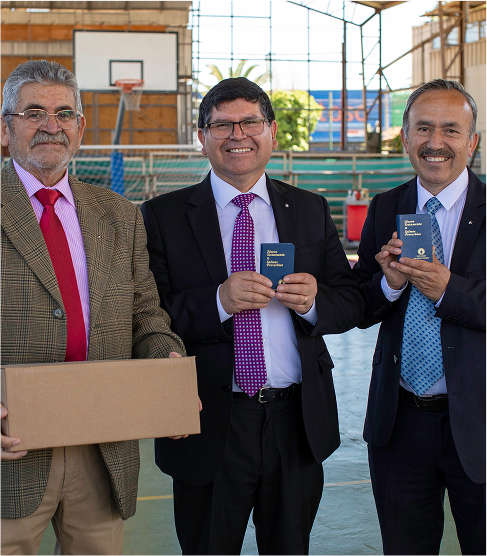 Men standing smiling with bibles