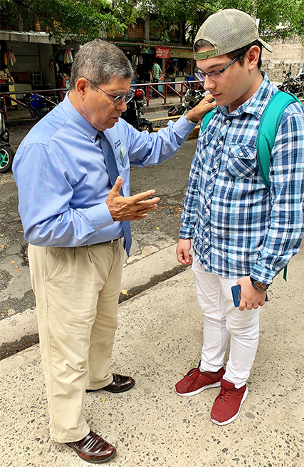 A Gideon prays with Carlos after a church service.