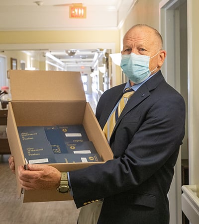 A Gideon preparing to distribute Scriptures.